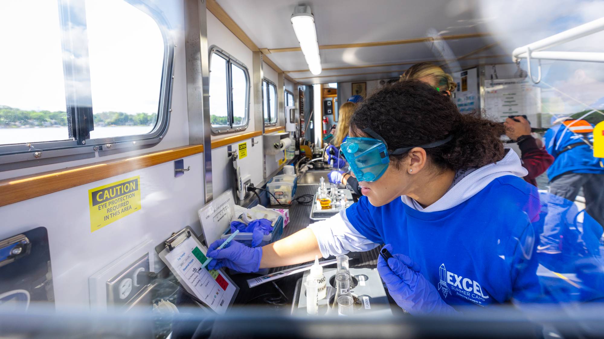 Students conduct lab analyses during a cruise on the W.G. Jackson